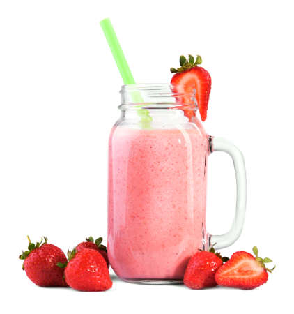 A mason jar full of fresh and organic yogurt from sweet strawberries and milk, isolated on a white background. Delicious pink smoothie with green straw and berries around and a top of a glass. A pink milkshake.の写真素材