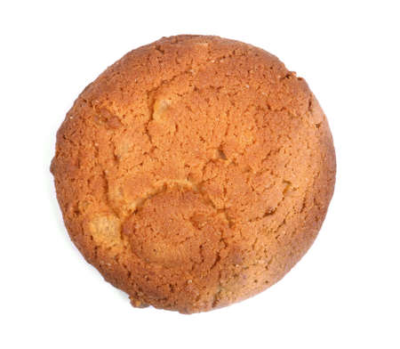 Single round ginger biscuit, isolated on a white background. A round oatmeal cookie. Homemade biscuit. Food, culinary, baking and eating concept. Cereal cookie. Bread products.の写真素材