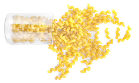 A transparent and inverted glass with uncooked pasta.Raw and fresh flour product. Flour products. Bright yellow dry maccheroni, isolated on a white background. Italian rigate pasta.の写真素材