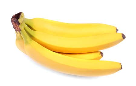 A bunch of organic, sweet, juicy yellow bananas, isolated on a white background. Tropical and sweet fruits. Delicious bananas full of nutritious vitamins.の写真素材