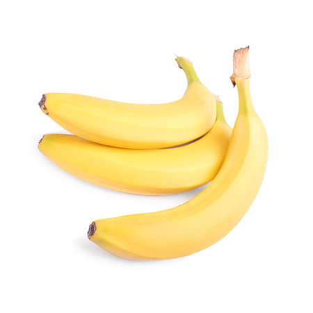 A group of tropical fruits. Three whole and fresh bananas, isolated on the white background. A bunch of ripe bananas. Vitamins. Raw, organic bunch of bright yellow bananas. Tasty and sweet fruits.の写真素材