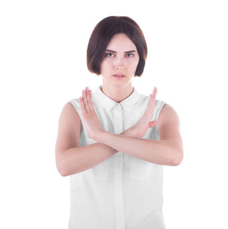 An expressive and disappointed young female isolated over the white background. A confident casual brunette lady crossing her hands in protest. Educational problems concept.の写真素材