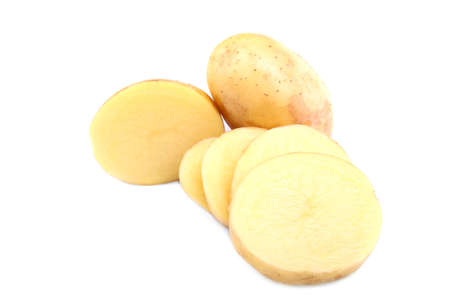 Beautiful fresh potatoes isolated over the white background. A whole raw potato and potatoes chopped in round slices. Preparation for delicious autumn dinners.の写真素材
