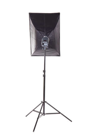 Lighting device on a tripod, isolated on a white background. Photo studio with lighting equipment. Profession studio flash with soft-box. Studio lighting. Pulse studio flashes with a square softbox.の写真素材