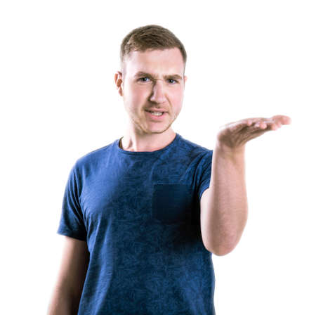 A disappointed student standing in a saturated blue shirt isolated over the white background. A...