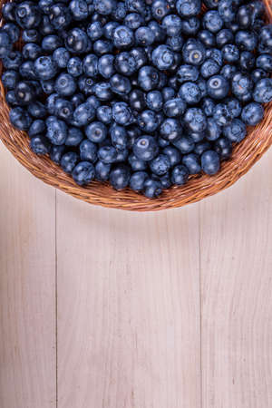 Close-up of fresh and bright blueberries. Healthy, ripe, raw and bright dark blue berries on a wooden background. Copy space.の写真素材