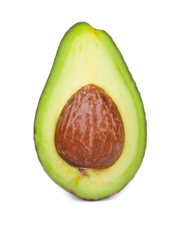 Macro picture of a green avocado half, isolated on a white background. A cut pear-shaped fruit with a rough leathery skin, edible flesh, and a large core. Healthy food.の写真素材