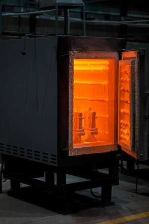 A huge furnace for heating steel. Dangerous technologies and occupations. A roasting oven on an industrial background.の写真素材