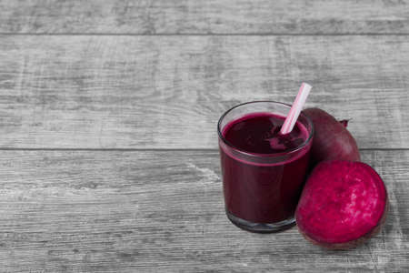 Healthy vegetable smoothie. Red beetroots. Beet juice on a spacious background. Vegan restaurants concept. Copy space.の写真素材