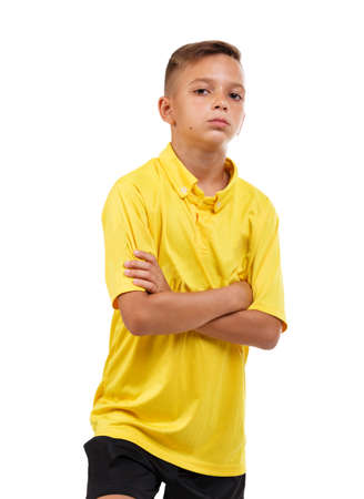 A handsome kid wearing a football uniform, isolated on a white background. Football, activities and healthy concept.の写真素材