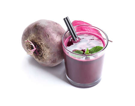 A top view of whole and cut beet and spicy green mint, isolated on a white background. A glass full...