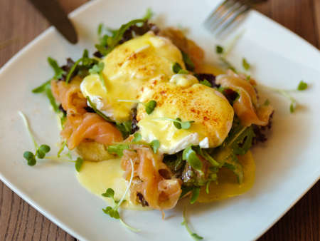 Poached eggs on a plate. Close-up of baked spicy eggs with salmoの写真素材