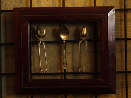 Decorative antique kitchen tools. Spoon and tools framed in woodの写真素材