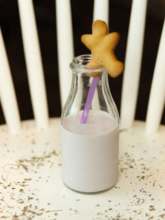 A top view of a bottle full of milk on a white table and on a blの写真素材