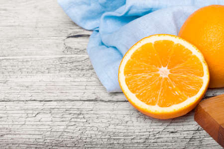 A cut in half exotic orange. Bright oranges on a wooden background. Antioxidant fruits for healthy drinks. Copy space.の写真素材