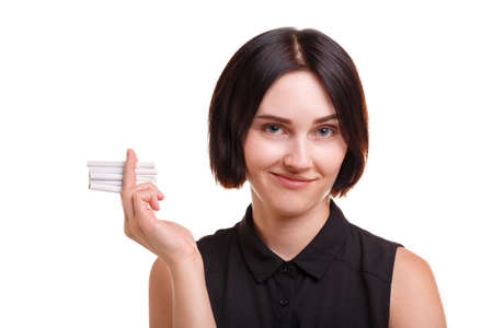 Sassy girl with cigarettes. Nicotine addict holding cigarettes isolated on a white background....