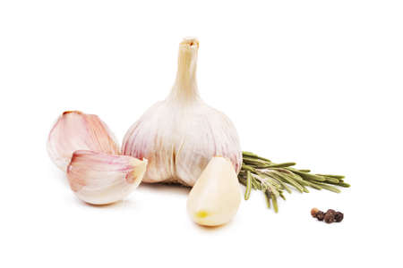 Close-up of a whole garlic and herbs, isolated on a white background. Garlic cloves and garlic bulb with rosemary.の写真素材