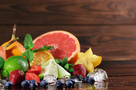 Juicy blueberries, bright grapefruit, fresh green leaves of mint, green lime, cubes of ice,...