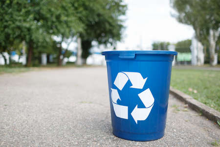 Bright recycle bin with label on the road without people. Concept of envirometal protection. Cleaned outside terrain.の写真素材