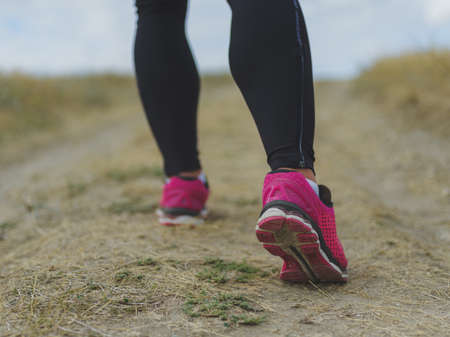 Closeup muscular legs. Man running on a blurred background. Running, jogging, walking concept....