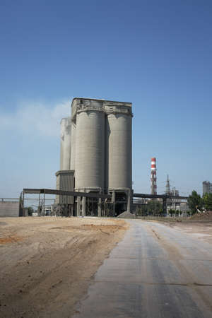 Industrial plant on a sky background. A huge building and a smokestack of a dairy factory. Ecology...