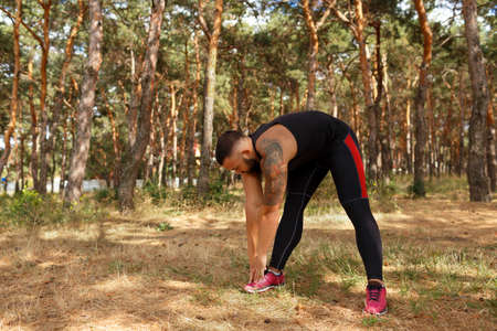 A photo of an athletic, strong male doing workout on a natural background. Healthy lifestyle...