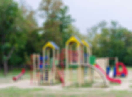 Colorful blurred playground equipment in the park. Bright modern playground for little children. Childhood concept.の写真素材