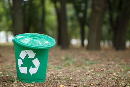 Colorful recycle bin with label in the park without people. Outside photo, land on the background.の写真素材