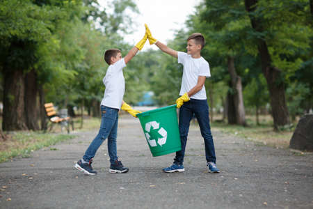 Group of kids volunteer help garbage collection charity environment, selective soft focus. Team work.の写真素材