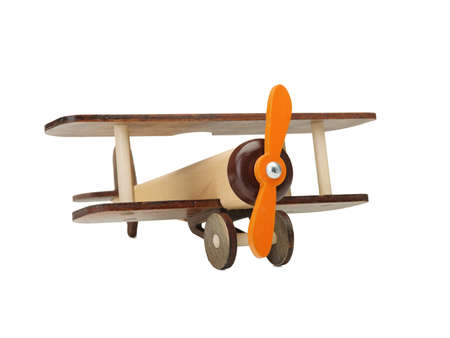 Wooden toy airplane isolated on white, close-up of an eco-friendly product for children's games, isolated on a white background. A developing toy airplane. Fight simulation.の写真素材