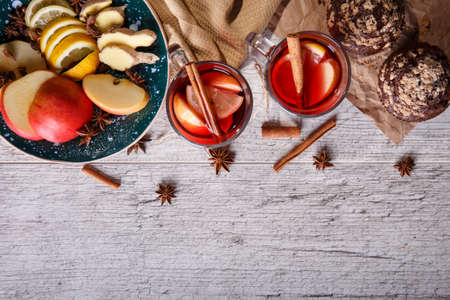 Hot red tea with fruits and chocolate muffins on a table background. Healthy breakfast. Copy space.の写真素材