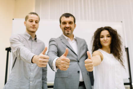 Businessman posing with staff members on the office background. Corporate business concept.の写真素材