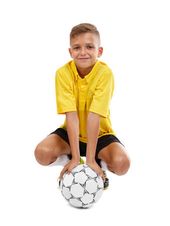 Young boy playing football isolated on white background. Sport concept.の写真素材