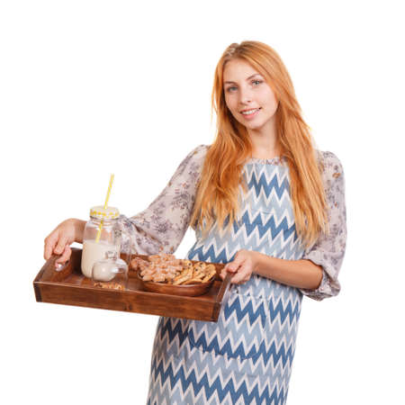 Beautiful young woman is holding a wooden tray with healthy food isolated on a white background. Food concept.の写真素材