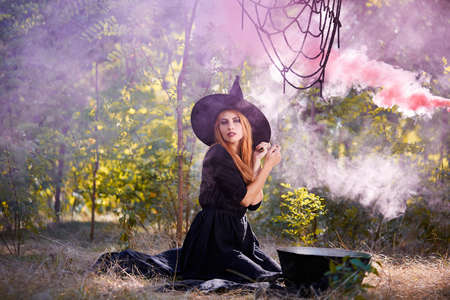 The forest enigmatic witch in the green wood outdoors.の写真素材