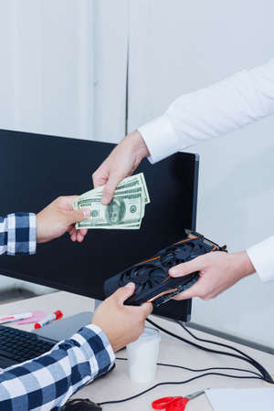 Close-up in the office video card and American currency. Cryptocurrency. Business and finance concept.の写真素材