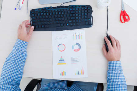 Close-up background of a workspace. Business and finance concept. Man's hands with the documents close-up.の写真素材