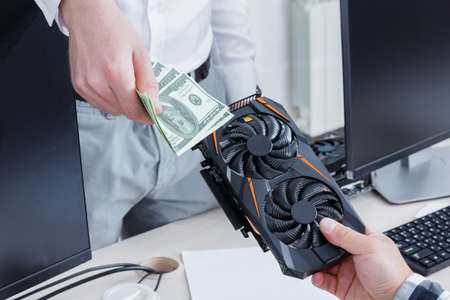 Close-up in the office video card and American currency. Cryptocurrency. Business and finance...