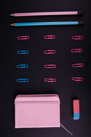 Close-up in horizontal position of a blue and pink office, an elastic band in an upright position...
