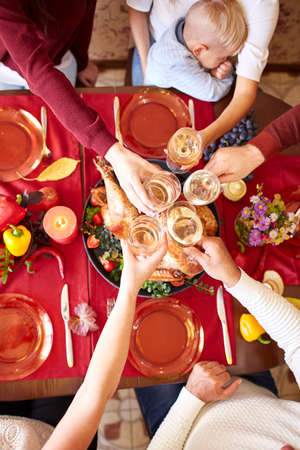 Top view of cheering glasses on Christmas on a blurred background. Family Thanksgiving dinner. Celebrating concept.の写真素材