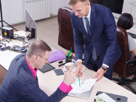 Young colleagues working in the office, Discussion.Cript currency.の写真素材