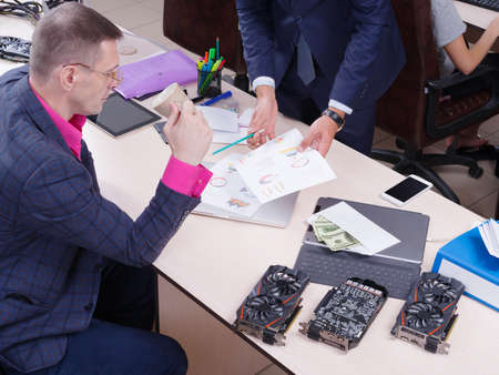 Young colleagues working in the office, Discussion.Cript currency.の写真素材