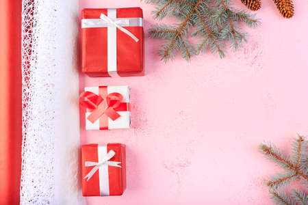 Beautiful gift boxes with a red and white bow on a pink background.の写真素材