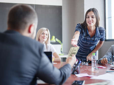 Business consultants working in a team. A group of young workers at a meeting in the company...