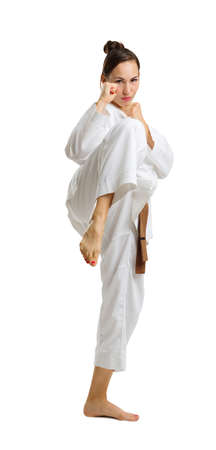 A young girl in a karate pose. Isolated on white background.の写真素材