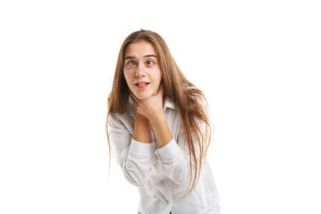 Portrait of a young girl on a white background that smothers herself. Isolated on white background.