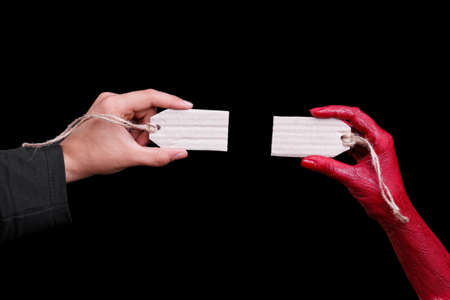Human hands painted in red are posing on a black background. Halloween concept.の写真素材