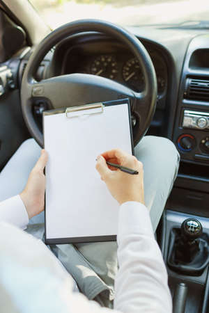 Attractive handsome elegant man in a business suit driving an expensive car.の写真素材