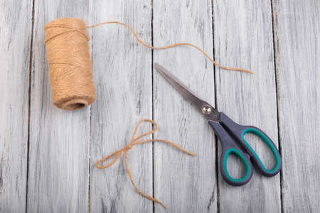 Top view on a ball of threads on the wooden background.の写真素材
