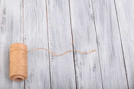 Top view on a ball of threads on the wooden background.の写真素材